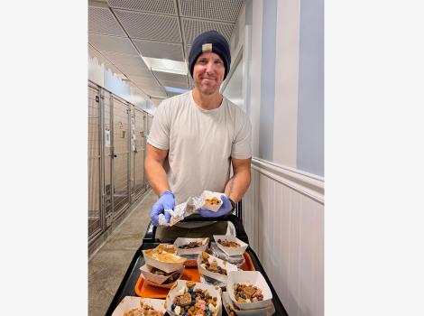 Alex Mestres volunteering by bringing meals to pets at Best Friends in Los Angeles