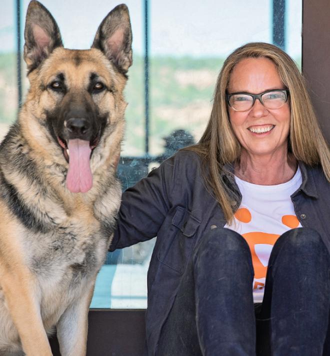 Julie Castle Seated with two large dogs