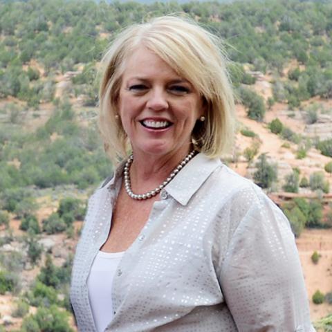 Lynn Flanders standing with canyon in background